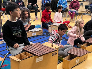 students playing a musical instrument in a classroom